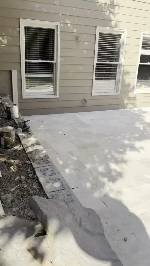 Paver patio being laid under a deck